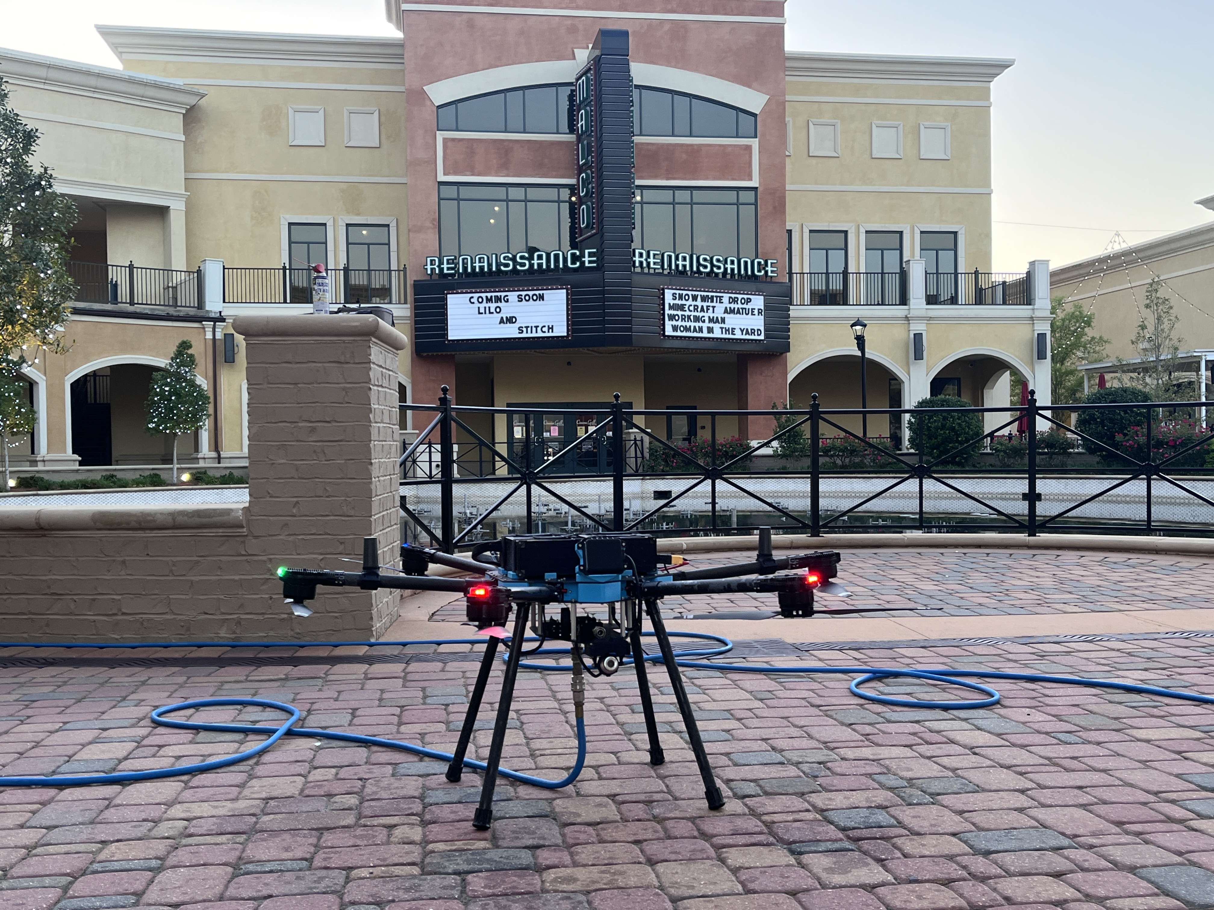 Drone washing a commercial building